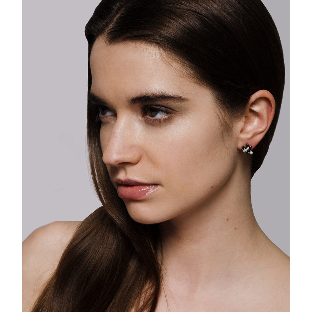 Model wears oxidised silver and pearl cluster stud earrings. Handmade by Yen Jewellery