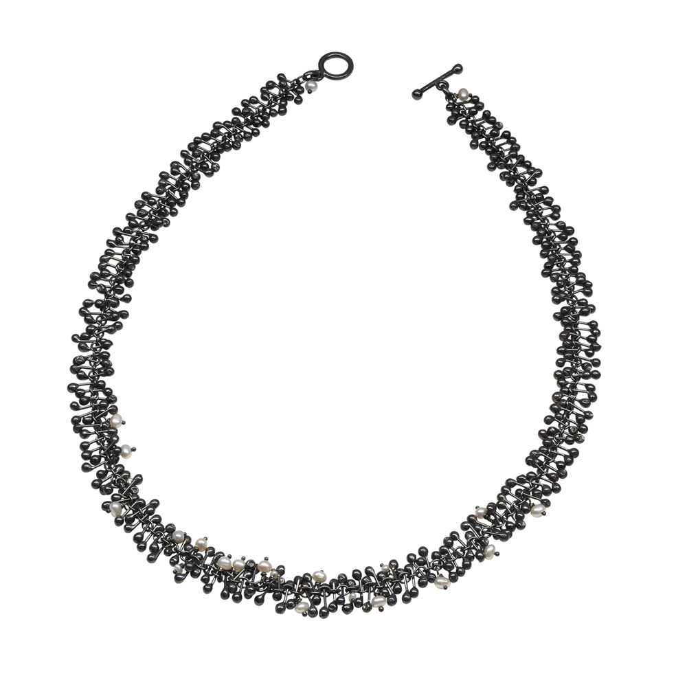 Freshwater pearls and handmade oxidised silver beads create this statement necklace. Perfect for livening up work attire or complementing evening wear.