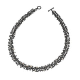 Freshwater pearls and handmade oxidised silver beads create this statement necklace. Perfect for livening up work attire or complementing evening wear.