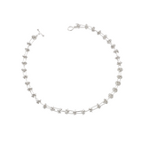 Soft, silver domes are connected by silver pillar-like bars. The unique design looks structured yet it feels soft to the touch.