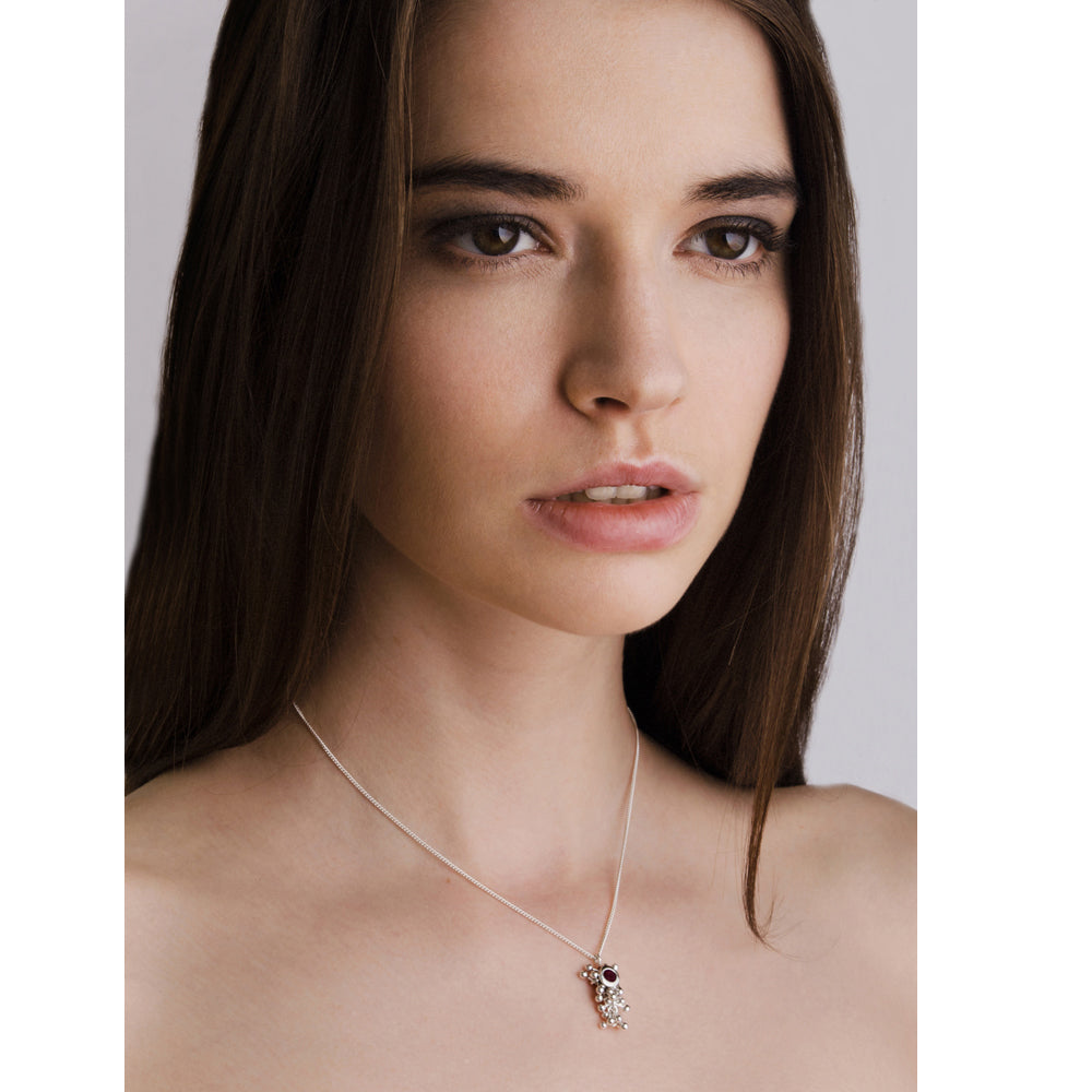 Model wears Molecule Ruby Drop Necklace. A ruby set in a cluster of handmade silver beads.