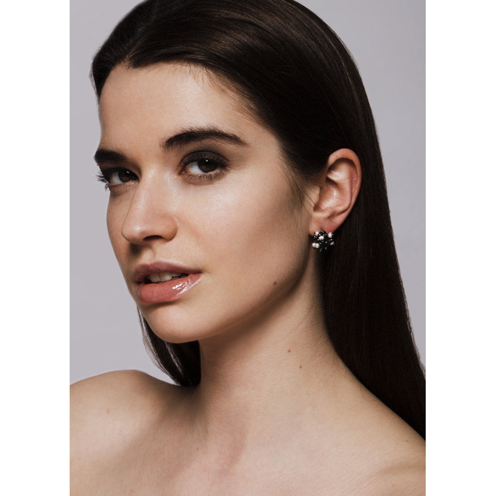 Model wears oxidised silver and pearl cluster stud earrings. Made by Yen Jewellery