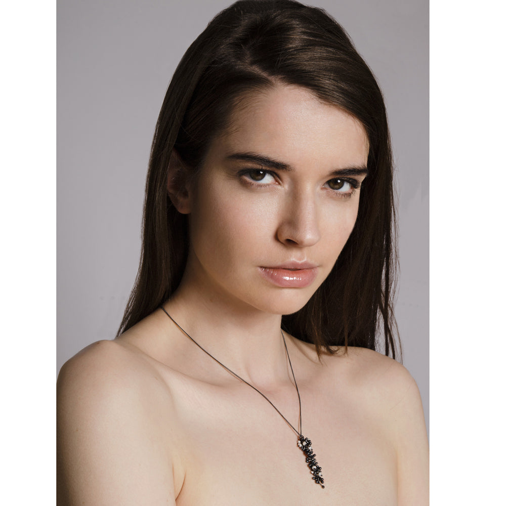 Model wears oxidised silver and pearl drop necklace. Handmade by Yen Jewellery