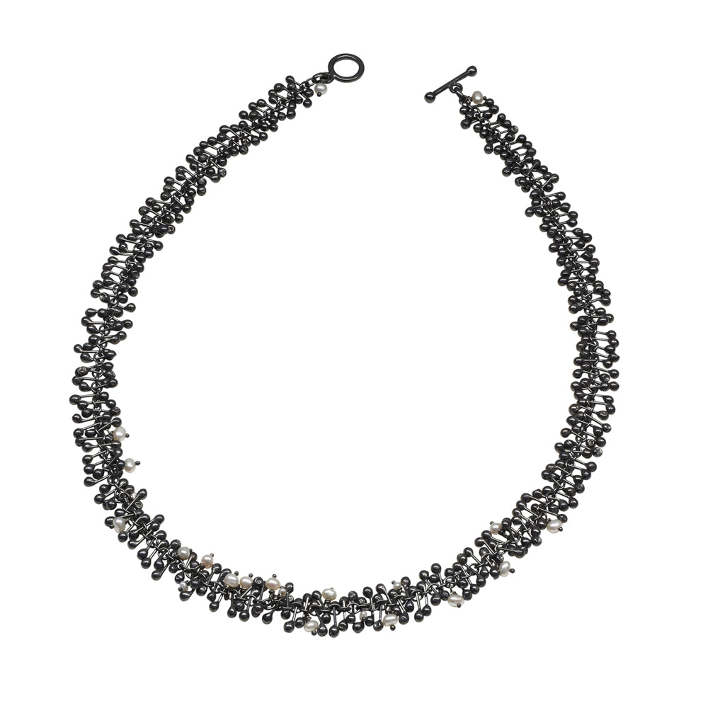 Freshwater pearls and handmade oxidised silver beads create this statement necklace. Perfect for livening up work attire or complementing evening wear. 