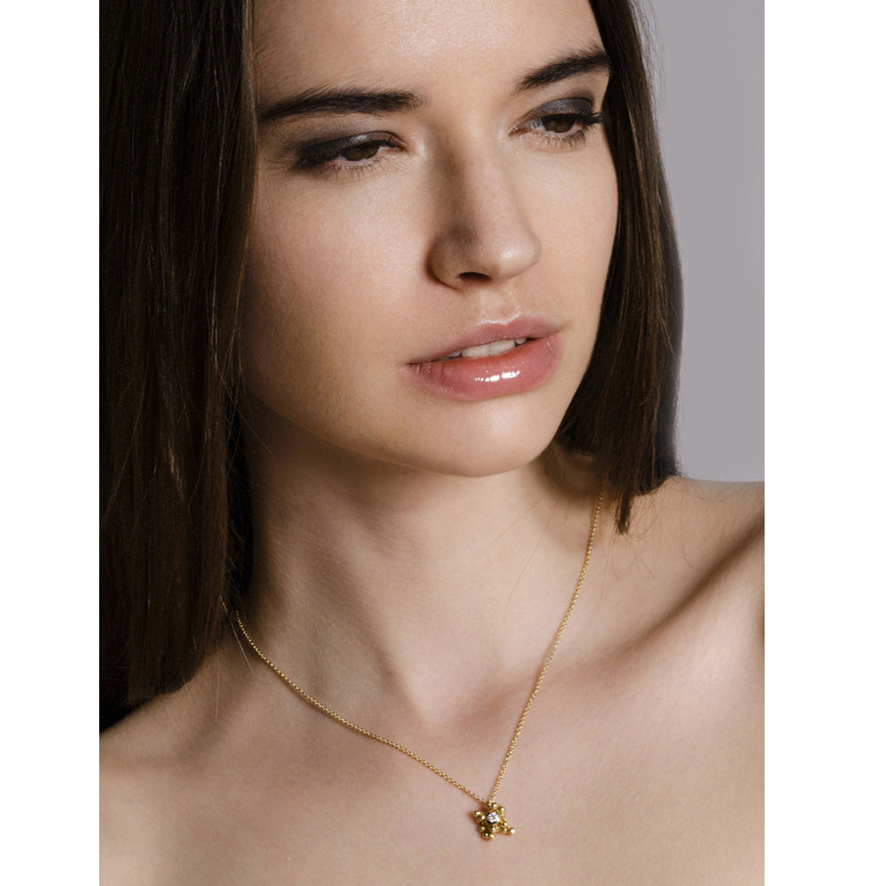 Model wears 18ct gold and diamond cluster necklace. Cluster hangs from an 18ct gold chain. Handmade by Yen Jewellery