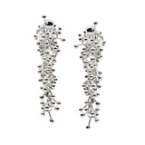 A long dense cluster of silver connective elements create this pair of earrings. Designed and handmade by Yen Jewellery