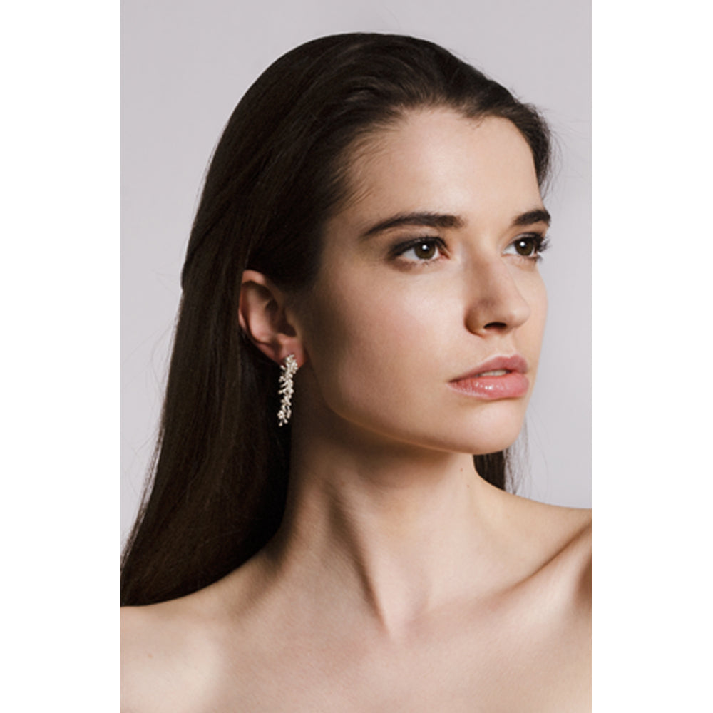 Model wears silver molecule drop earrings. Yen Jewellery