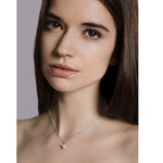 Model wears a delicate cluster of silver and freshwater pearls. Hangs from a chain. Handmade by Yen Jewellery