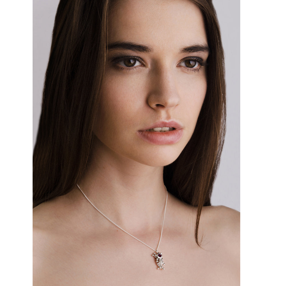 Model wears Molecule Ruby Drop Necklace. A ruby set in a cluster of handmade silver beads. 